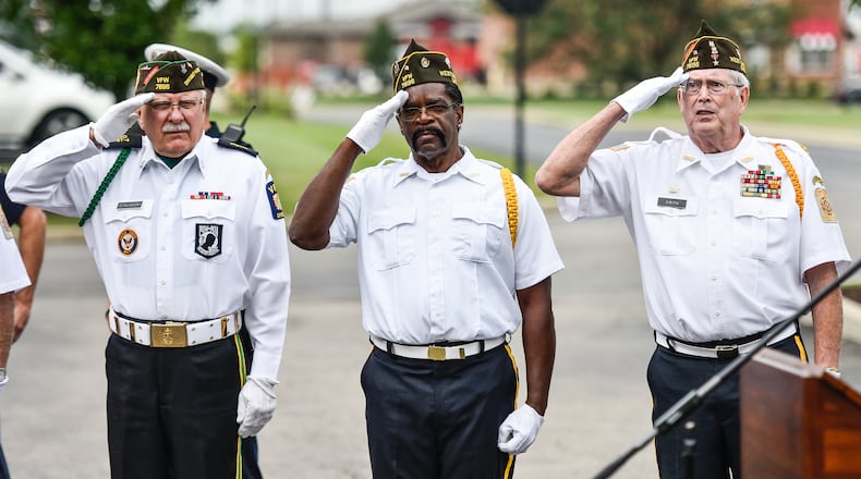 Several 9/11 events are planned throughout Butler and Warren counties Saturday in recognition of the 20th anniversary. Here, Ron Dzikowski, left, Donald Carter and Dave Smith, members of the West Chester VFW 7696 Color Guard, salute the flag during a 9/11 remembrance ceremony on Sept. 11, 2018 at Chesterwood Village Senior Living Community on Tylersville Road in West Chester Twp. NICK GRAHAM/STAFF