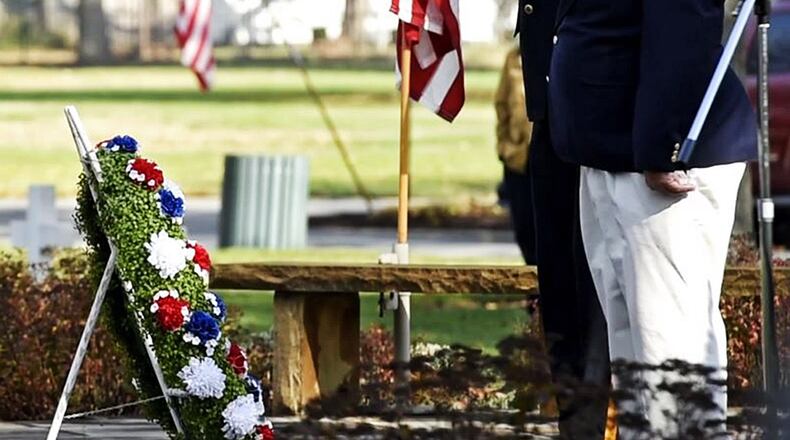 American Legion Post 218 Commander Mike Gomia, right, and Mark Singh, VFW Post 3809 Commander, salute after placing a wreath on the World War II memorial during the Veterans Day ceremony last year at Woodside Cemetery and Arboretum in Middletown. NICK GRAHAM/STAFF FILE
