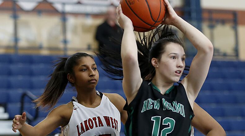 New Miami guard Arielle Scalf looks for a teammate as Lakota West guard Bryana Henderson covers her during the All-Butler County All-Star girls basketball game at the Hamilton Athletic Center on April 7, 2018. CONTRIBUTED PHOTO BY E.L. HUBBARD