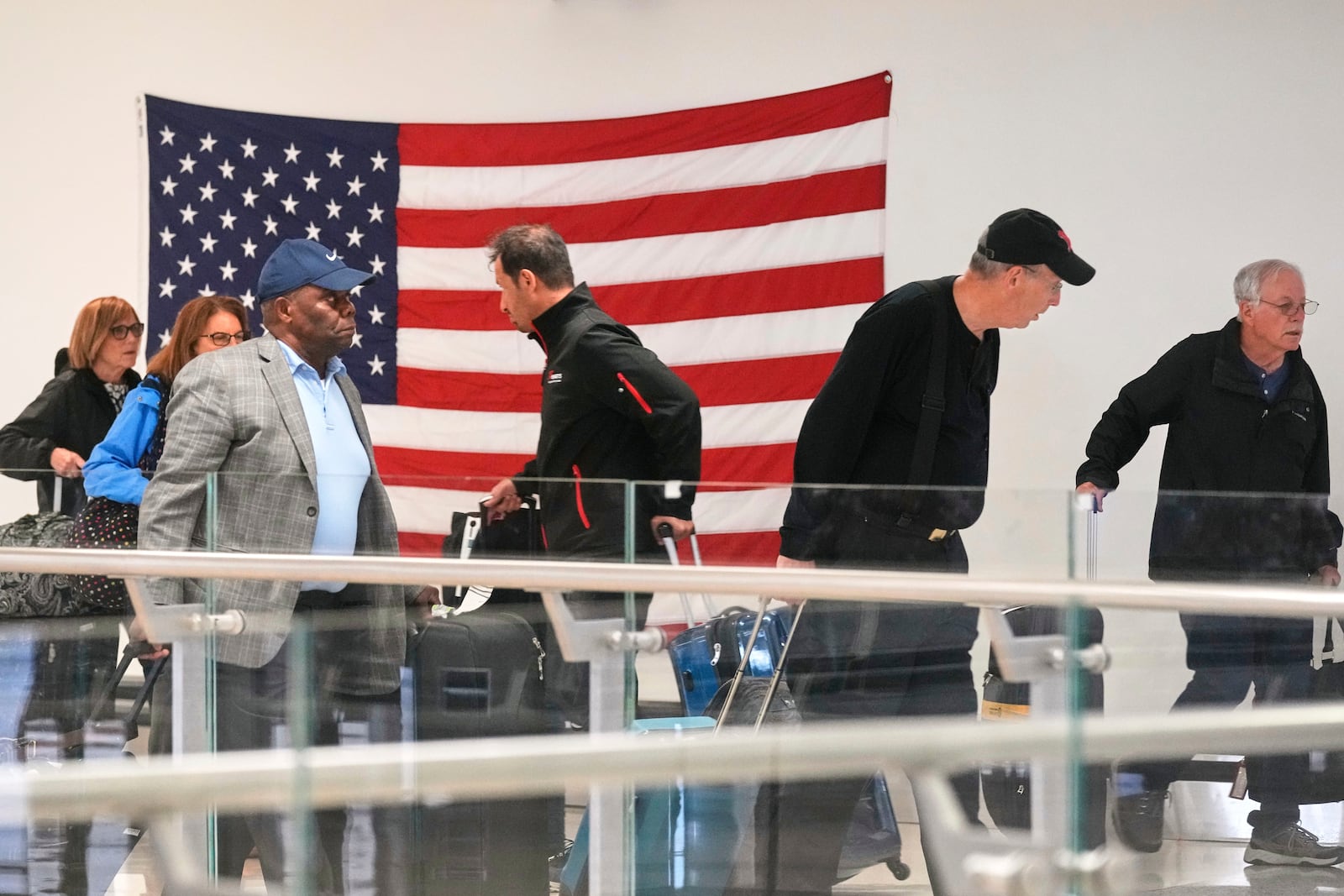 Passengers traverse Newark Liberty International Airport, in New Jersey, Friday, May 23, 2025. (AP Photo/Richard Drew)