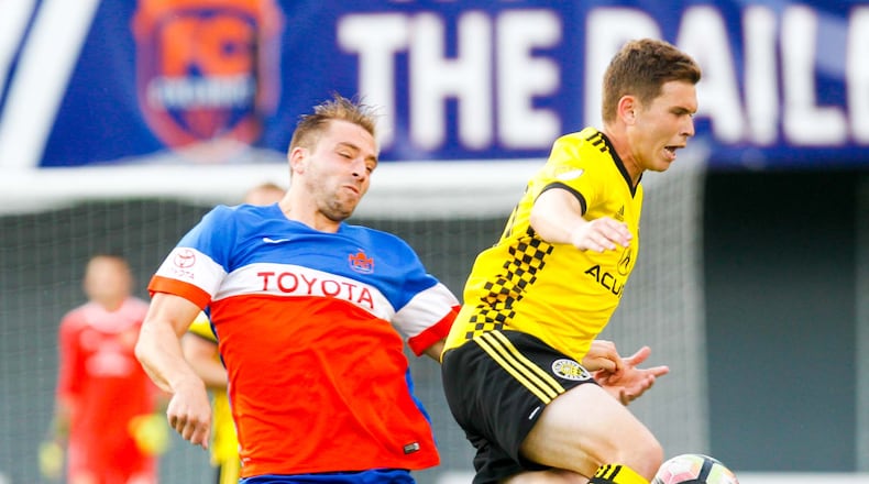 FC Cincinnati defender Matt Bahner (2) collides with Columbus Crew Will Trapp (20) during their Open Cup match held at Nippert Stadium on the campus of the University of Cincinnati, Wednesday, June 14, 2017. GREG LYNCH / STAFF