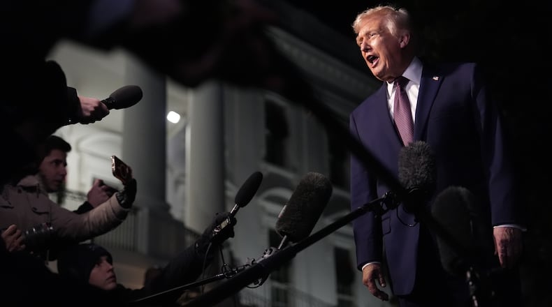 FILE - President Donald Trump talks to the media as he walks to Marine One from the White House, Friday, Dec. 19, 2025, in Washington. (AP Photo/Julia Demaree Nikhinson, File)