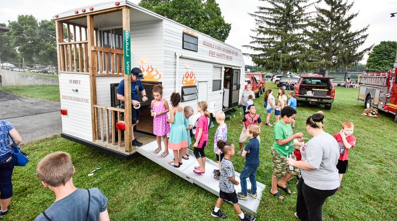 Children check out the Middletown fire department's fire house to learn about fire safety during Middletown's National Night Out event Tuesday, Aug. 7 at Berachah Church in Middletown. NICK GRAHAM/STAFF