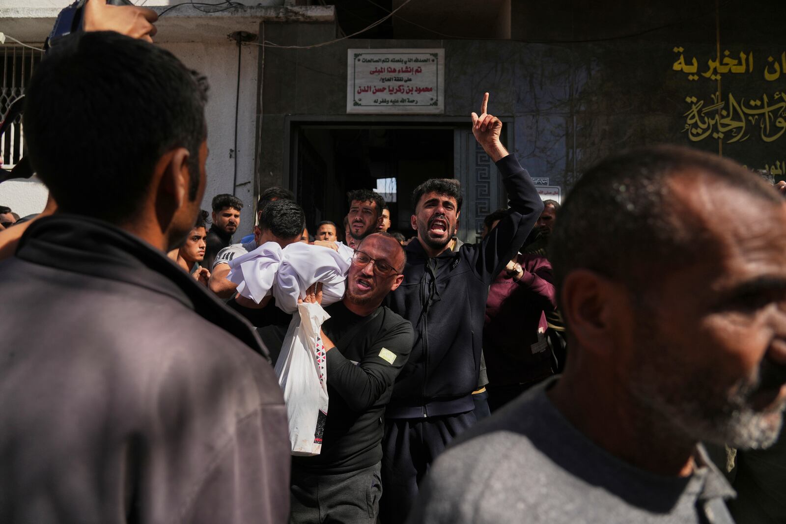 Bodies of some of the victims of an Israeli army strike on a restaurant, which killed at least 29 people, are carried at the Shifa hospital in Gaza City, Wednesday, May 7, 2025.(AP Photo/Jehad Alshrafi)