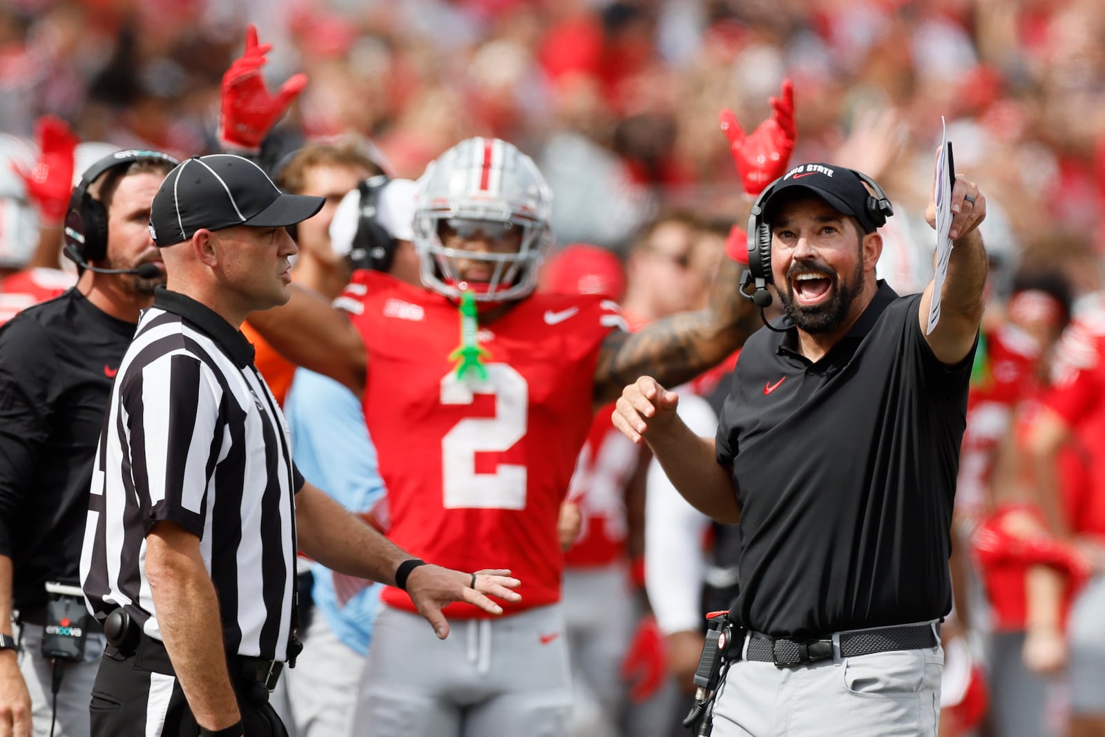 Ohio State head coach Ryan Day, right, argues with a referee during the first half of an NCAA college football game against Akron, Saturday, Aug. 31, 2024, in Columbus, Ohio. (AP Photo/Jay LaPrete)