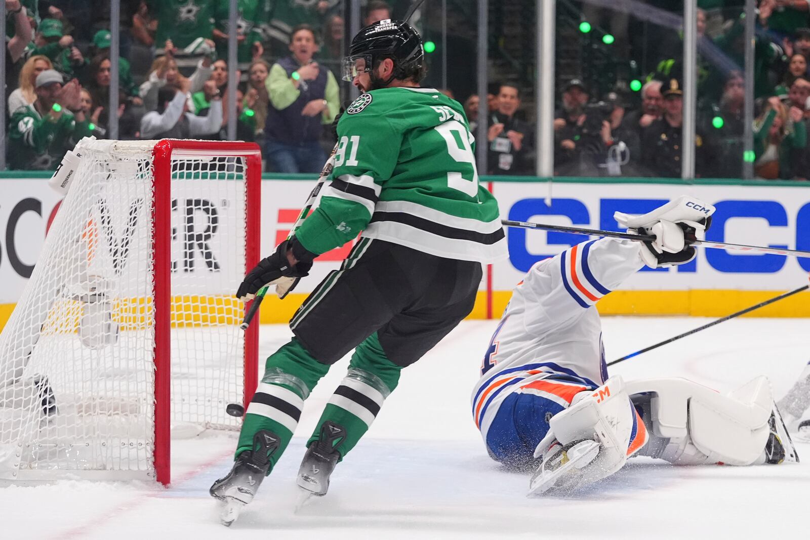Dallas Stars center Tyler Seguin (91) scores a goal against Edmonton Oilers goaltender Stuart Skinner (74) during the first period in Game 1 of the Western Conference finals in the NHL hockey Stanley Cup playoffs against the Dallas Stars, Wednesday, May 21, 2025, in Dallas. (AP Photo/LM Otero)