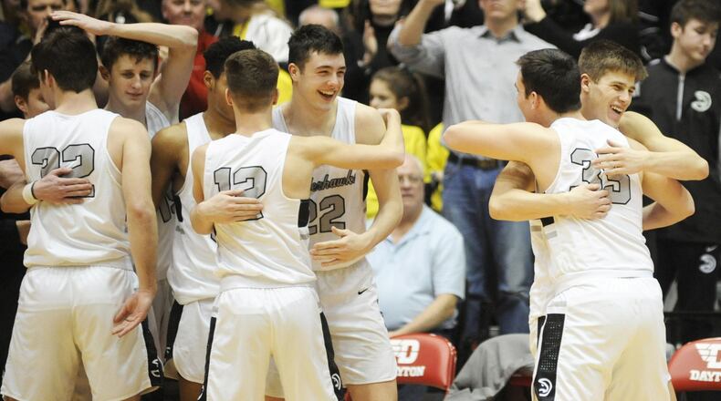 Lakota East players celebrate after defeating Fairmont 50-36 in a Division I district basketball final last Saturday at the University of Dayton Arena. MARC PENDLETON/STAFF