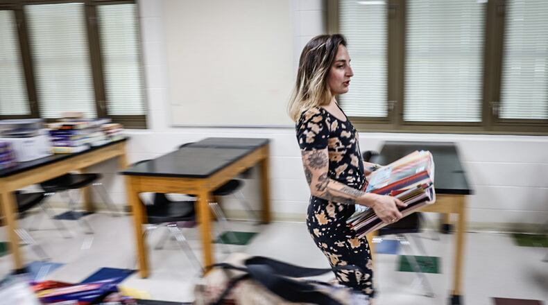 E.J. Brown Middle School science teacher Casi Hardin prepares her classroom for the first day of school Monday. JIM NOELKER/STAFF