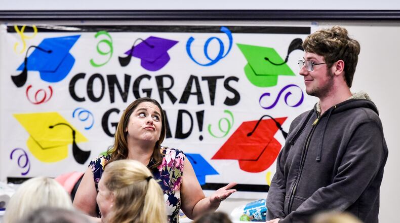 Two Butler County departments, Children Services and Developmental Disabilities have made strides in recent years, both fiscally and in dealing with the rampant opioid epidemic. Pictured here is case worker Amanda Hinkle as she congratulates Tyler Holt on his graduation during the annual Butler County Children Services graduation ceremony. NICK GRAHAM/STAFF