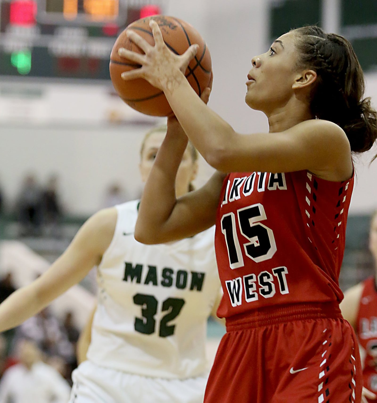 Lakota West’s Sarah Jones launches a shot in front of Mason’s Sammie Puisis during their game at the Mason Arena on Saturday afternoon. CONTRIBUTED PHOTO BY E.L. HUBBARD