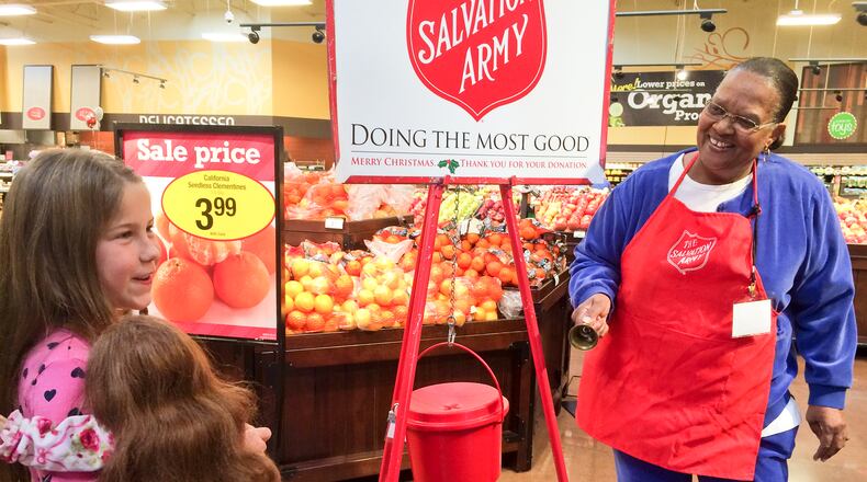 In this file photo, a volunteer collects money during the Salvation Army’s Red Kettle Campaign. The Salvation Army of Hamilton is running low on volunteer bell ringers collecting donations through its annual Red Kettle campaign during the holiday season. FILE PHOTO