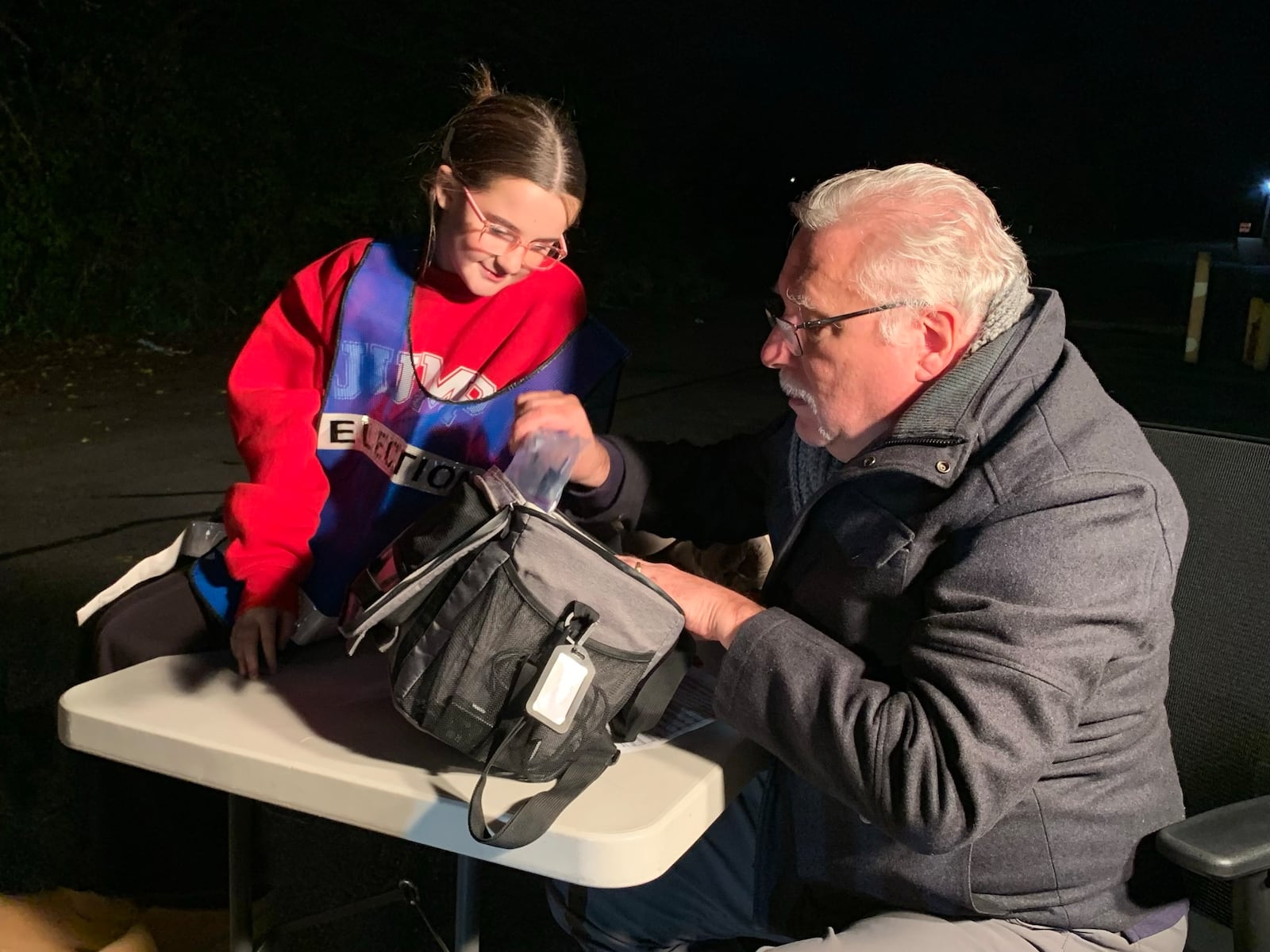 Bryan Pflanzer and his granddaughter Kyndall inspect election materials as precinct workers return them Tuesday night, Nov. 4, 2025. LONDON BISHOP/STAFF