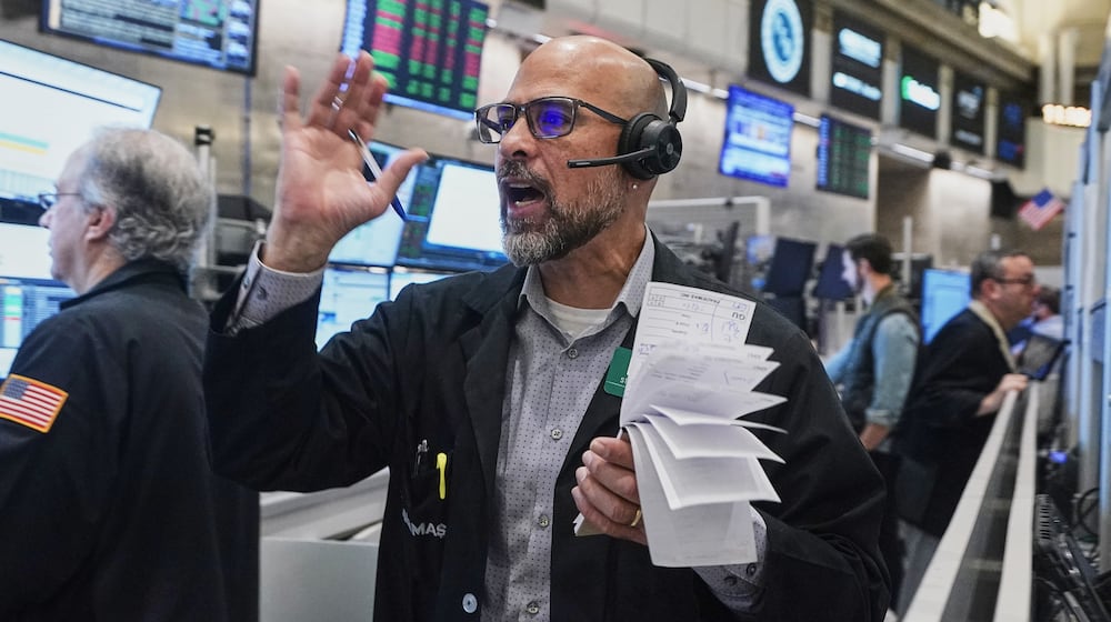 Options trader Steven Rodriguez works on the floor of the New York Stock Exchange, Friday, Nov. 21, 2025. (AP Photo/Richard Drew)