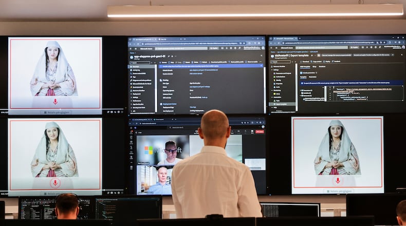 FILE - Albanian experts work at the National Agency for Information Society as an artificial intelligence "minister" Diella, whose name means "Sun" in Albanian, is seen on the screens in Tirana, Albania, Friday, Sept. 12, 2025. (AP Photo/Vlasov Sulaj, File)