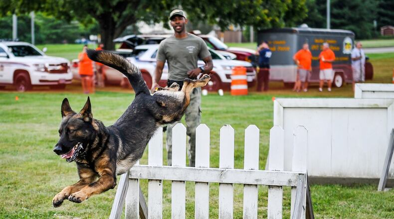 Chase, a Middletown canine officer, has retired and the department is adding three canine officers, giving the department five. Here, Chase, under the watchful eye of his partner Ryan Morgan, jumps a hurdle during National Night Out at Berachah Church. A similar demonstration is planned for this year’s event.