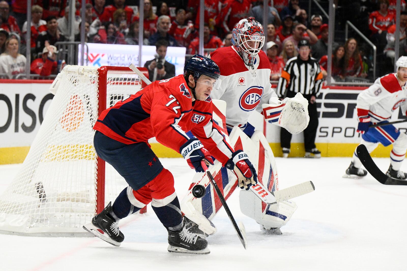Washington Capitals left wing Anthony Beauvillier (72) reaches for the puck past Montreal Canadiens goaltender Sam Montembeault (35) in the first period of Game 2 of a first-round NHL hockey playoff series, Wednesday, April 23, 2025, in Washington. (AP Photo/Nick Wass)