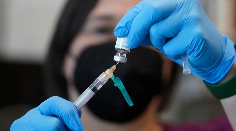 A registered nurse prepares a dose of a Monkeypox vaccine at the Salt Lake County Health Department Thursday, July 28, 2022, in Salt Lake City. The country’s monkeypox outbreak can still be stopped, U.S. health officials said Thursday, despite rising case numbers and so-far limited vaccine supplies.(AP Photo/Rick Bowmer)