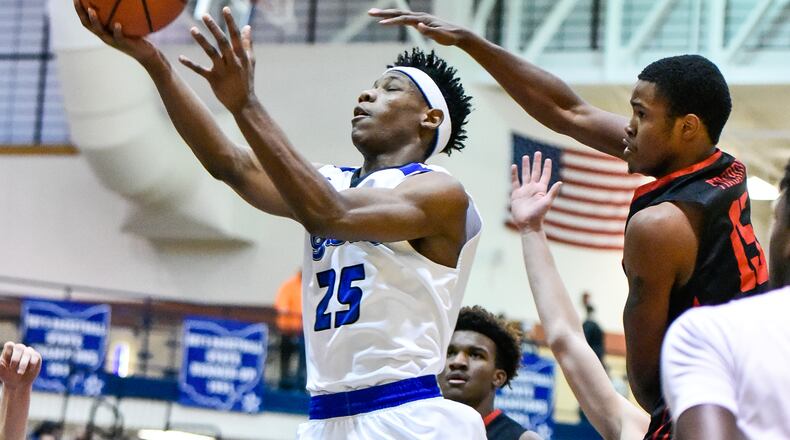 Lakota West’s Myles Greenwood tries to defend a shot by Hamilton’s D’Marco Howard during their basketball game Friday, Jan. 5 at Hamilton High School. NICK GRAHAM/STAFF
