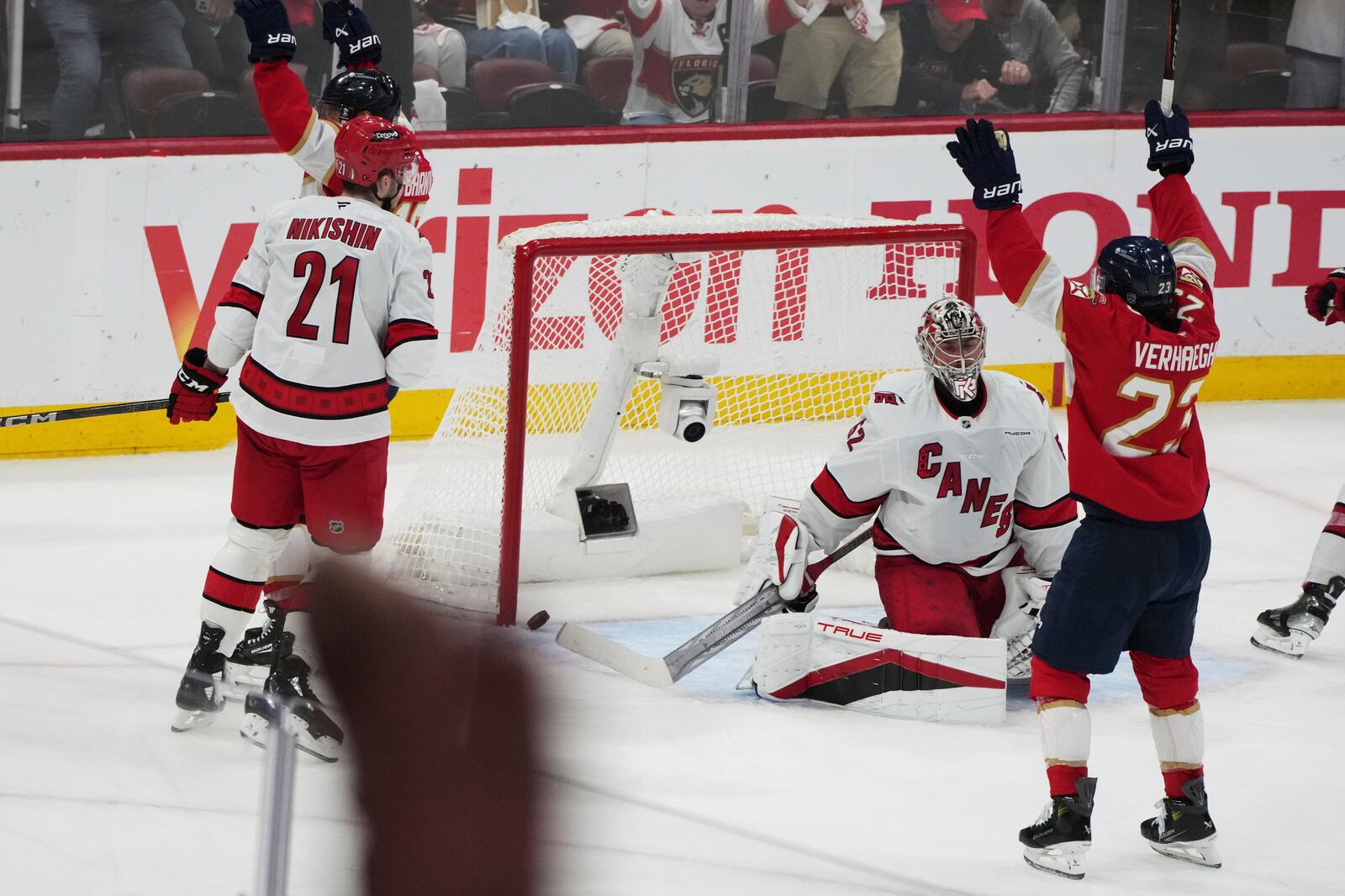 The puck gets past Carolina Hurricanes goaltender Pyotr Kochetkov, center, on a goal scored by Florida Panthers' Aleksander Barkov during the third period in Game 3 of the NHL hockey Stanley Cup Eastern Conference finals Saturday, May 24, 2025, in Sunrise, Fla. (AP Photo/Lynne Sladky)