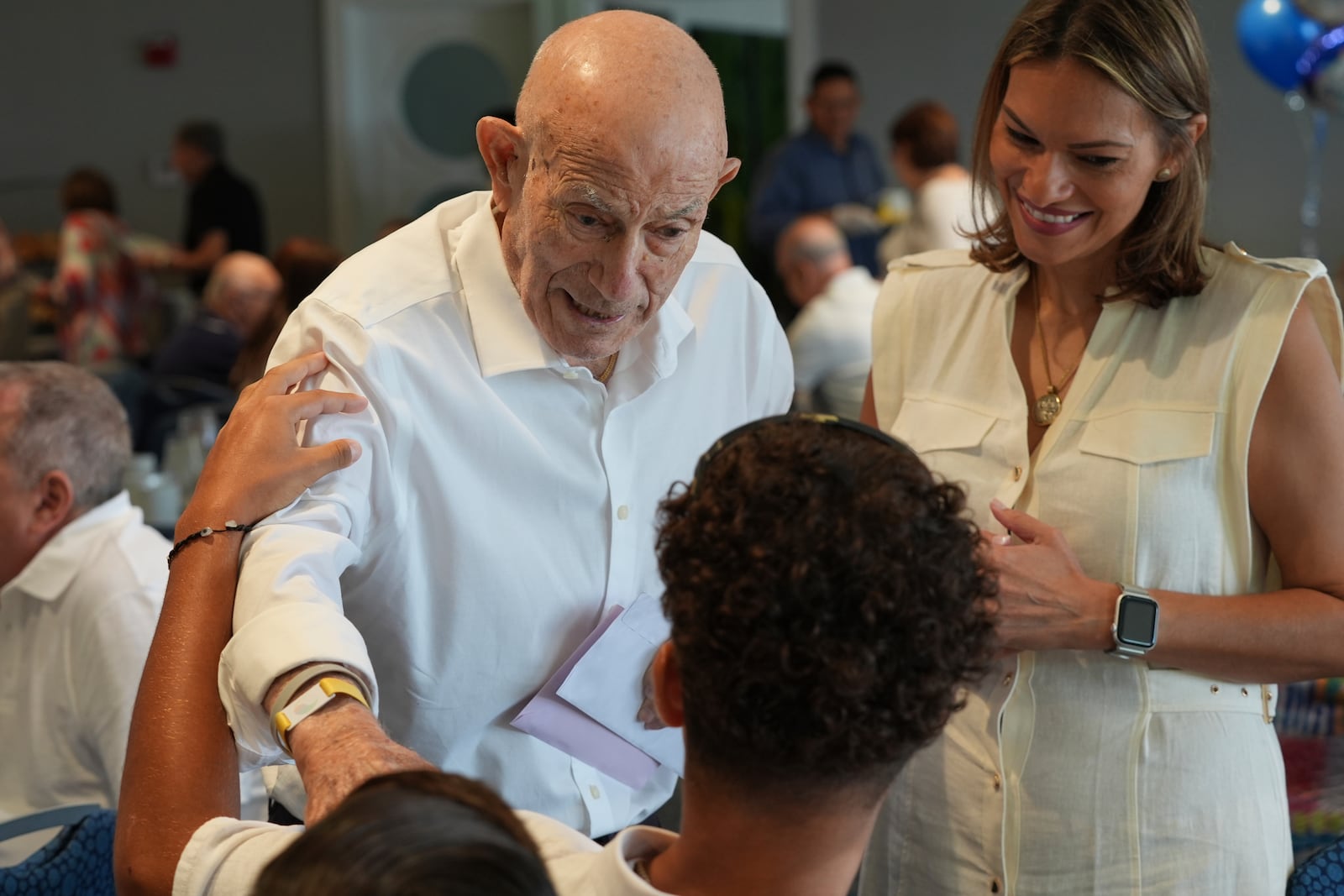 Harold Terens, a World War II veteran who fought in D-Day, greets friends at his 102 birthday party Saturday, July 26, 2025, in Delray Beach, Fla. (AP Photo/Marta Lavandier)