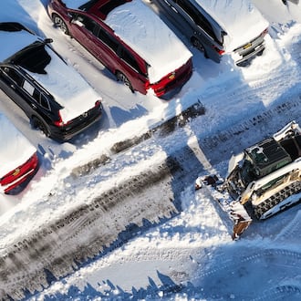 Crews clean up the lot at Matt Castrucci Auto Mall near the Dayton Mall on Monday, Jan. 26, 2026. NICK GRAHAM / STAFF