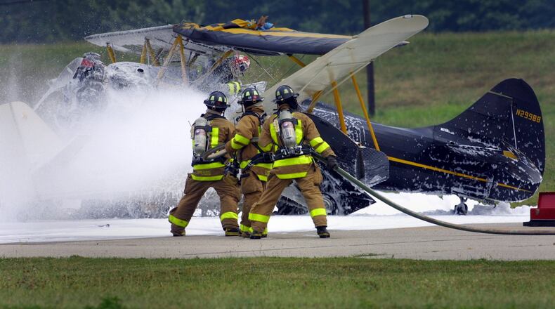Firefighters work on the scene of a two plane collision on the runway at Moraine Air Park in 2002. White fire retardant foam was sprayed on the planes and the surrounding area. Firefighting foams are under scrutiny because many contain PFAS chemicals. Two sites where PFAS has been used in firefighting foam, Wright-Patterson Air Force Base and Dayton's fire training center, sit above the aquifer. STAFF FILE