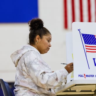 Rachelle Sims fills out a provisional ballots at the polling location in the gymnasium of Garfield Middle School Tuesday, Nov. 4, 2025 in Hamilton. NICK GRAHAM/STAFF