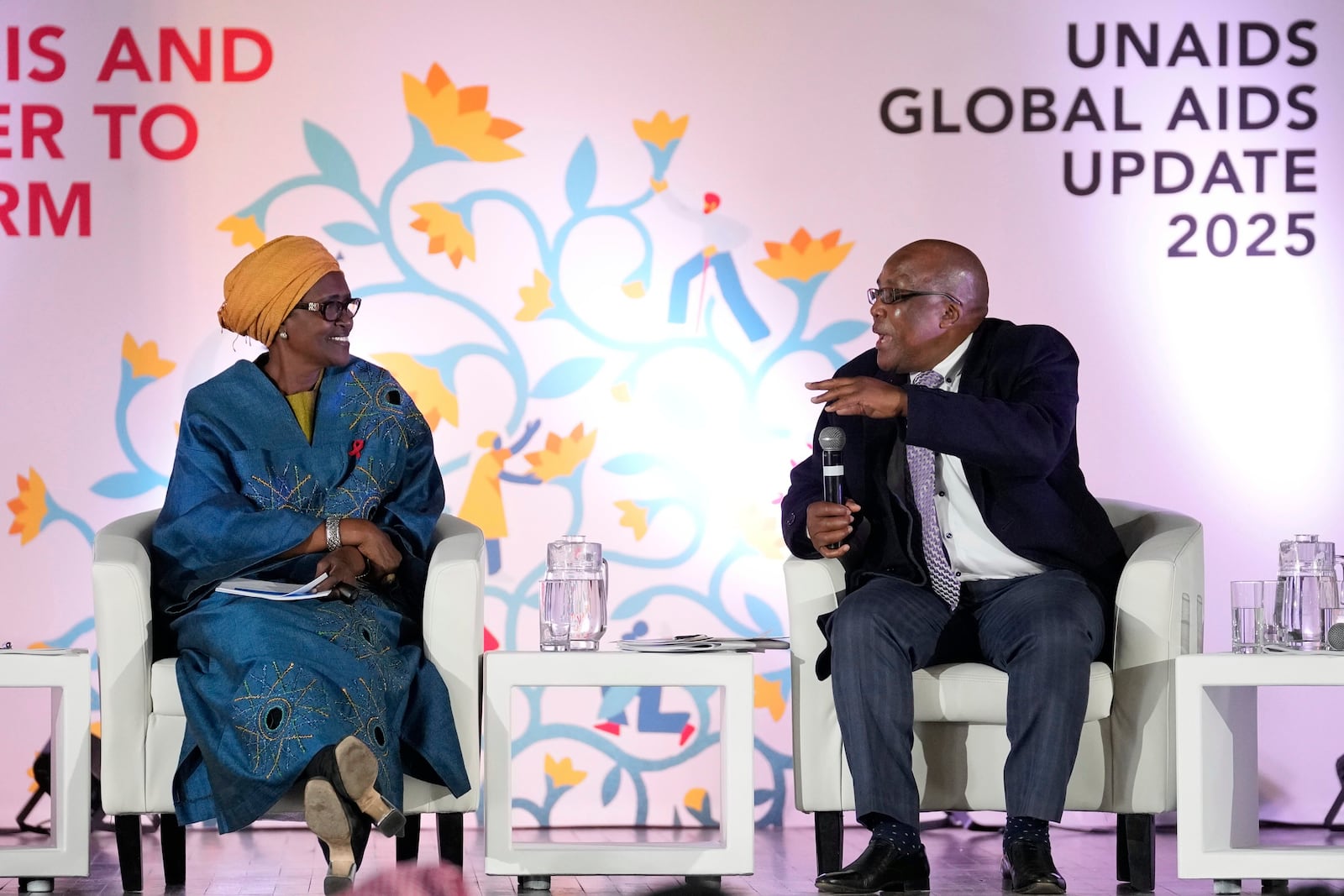 South Africa's Minister of Health Aaron Motsoaledi, right, speaks as Winnie Byanyima, Executive Director of UNAIDS and Under-Secretary-General of the United Nations watches on during the UNAIDS report release at Bertha Gxowa Hospital in Germiston, South Africa, Thursday, July 10, 2025. (AP Photo/Themba Hadebe)