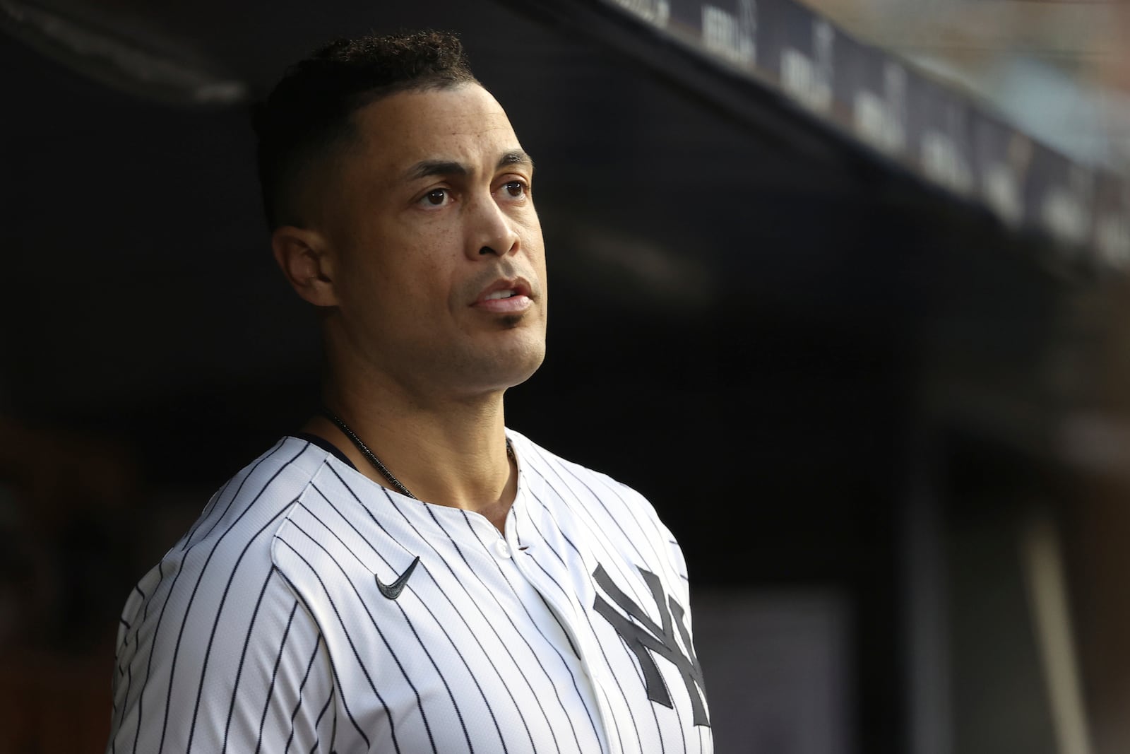 New York Yankees' Giancarlo Stanton stands in the dugout during the second inning of a baseball game against the Los Angeles Angels, Monday, June 16, 2025, in New York. (AP Photo/Pamela Smith)