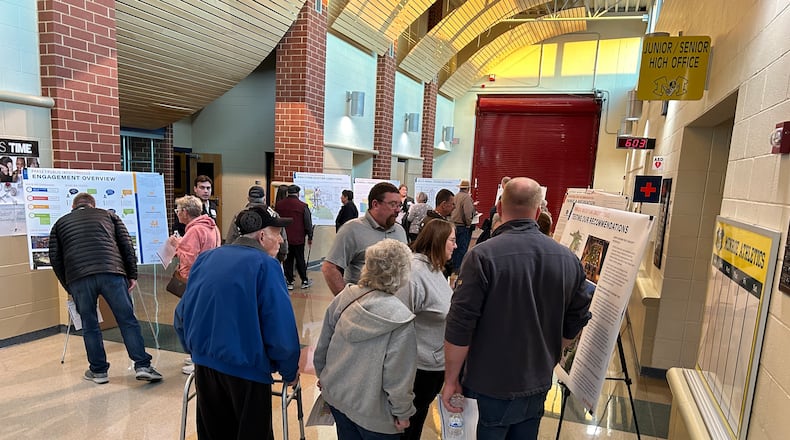 About 50 Monroe residents attended a Downtown Master Plan meeting Monday night at the high school. Several drawings of potential designs for the downtown area were displayed in the school lobby. RICK McCRABB/STAFF
