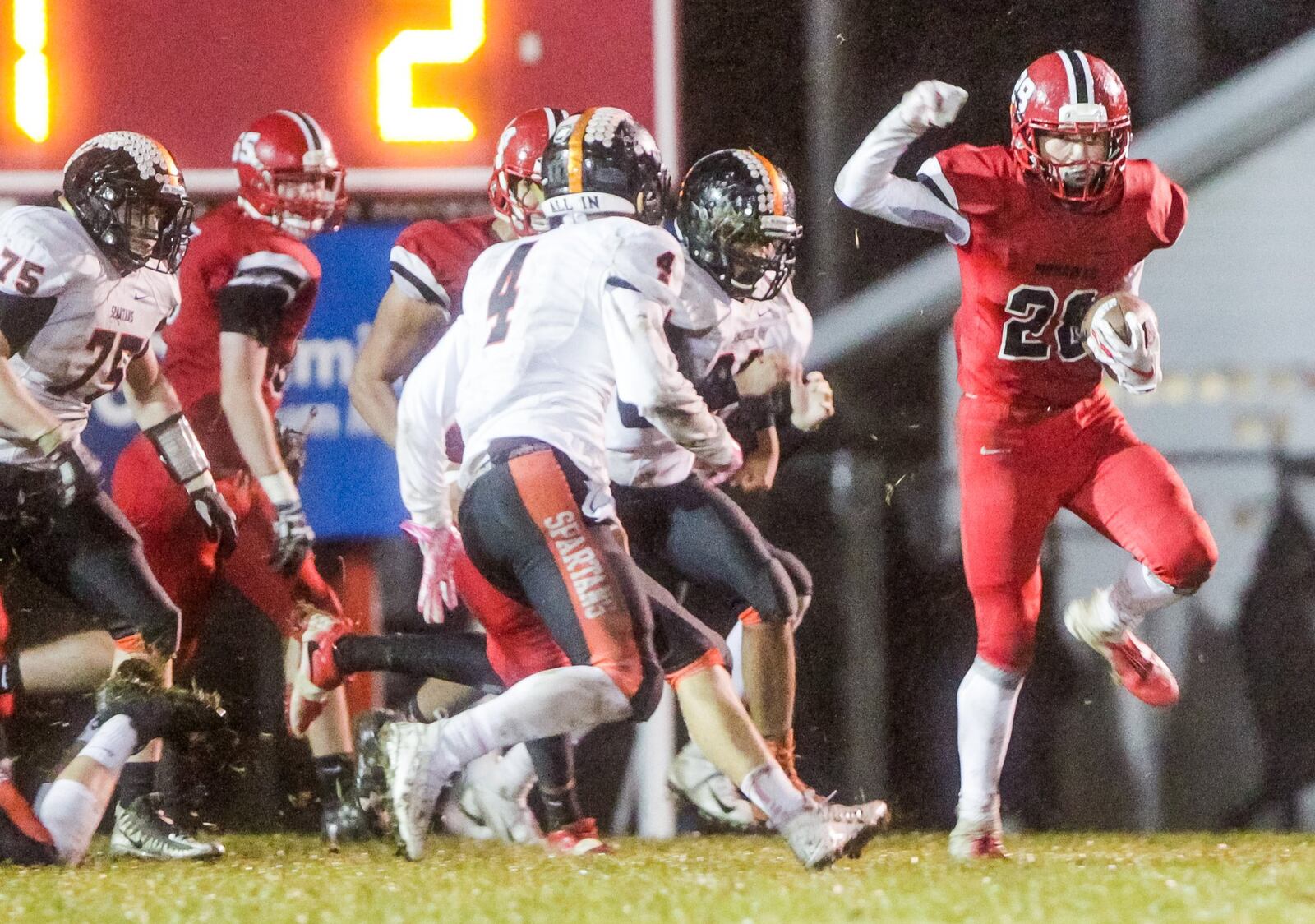 Waynesville’s Daniel Butterbaugh (4) can’t stop Madison’s Jake Phelps (28) from scoring a touchdown Friday night at Brandenburg Field in Madison Township. NICK GRAHAM/STAFF