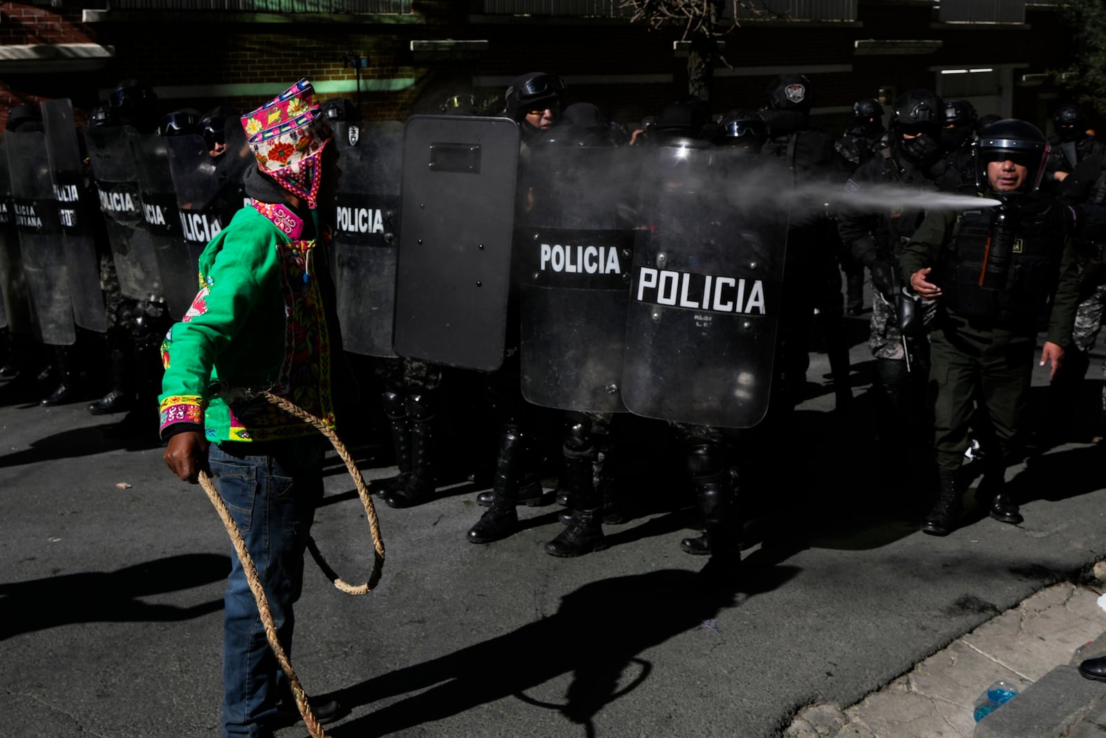 A supporter of former President Evo Morales confronts police during clashes near the offices of the Electoral Tribunal in La Paz, Bolivia, Friday, May 16, 2025. (AP Photo/Juan Karita)