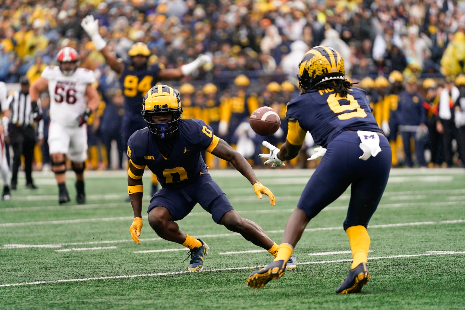 Michigan defensive back Rod Moore (9) intercepts an Indiana pass as Mike Sainristil (0) watches in the first half of an NCAA college football game in Ann Arbor, Mich., Saturday, Oct. 14, 2023. (AP Photo/Paul Sancya)