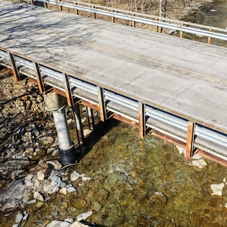 Butler County Engineer Greg Wilkens plans to spend nearly $14 million on bridge work this year to repair structures like this one on Shurz Road over Elk Creek in Wayne Twp. The cost to replace this bridge is $1.9 million and Wilkens received $1.8 million in federal funds to help pay for it. NICK GRAHAM VIA DRONE/STAFF