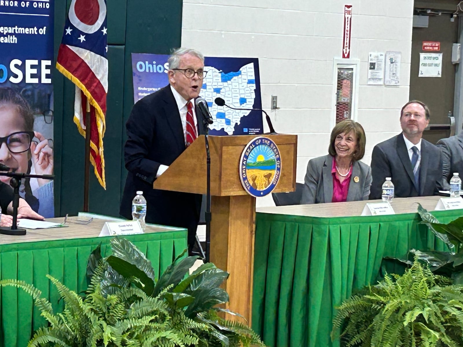 Ohio Gov. Mike DeWine addresses students and staff at New Miami Local School district Thursday afternoon. Several students received free glasses as part of the Ohio Student Eye Exam program. All Butler County schools are eligible for the program. RICK McCRABB/CONTRIBUTOR