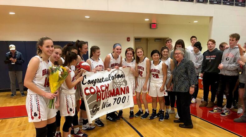 Talawanda coach Mary Jo Huismann celebrates with her players after winning her 700th game Saturday. Mark Schmetzer/CONTRIBUTED