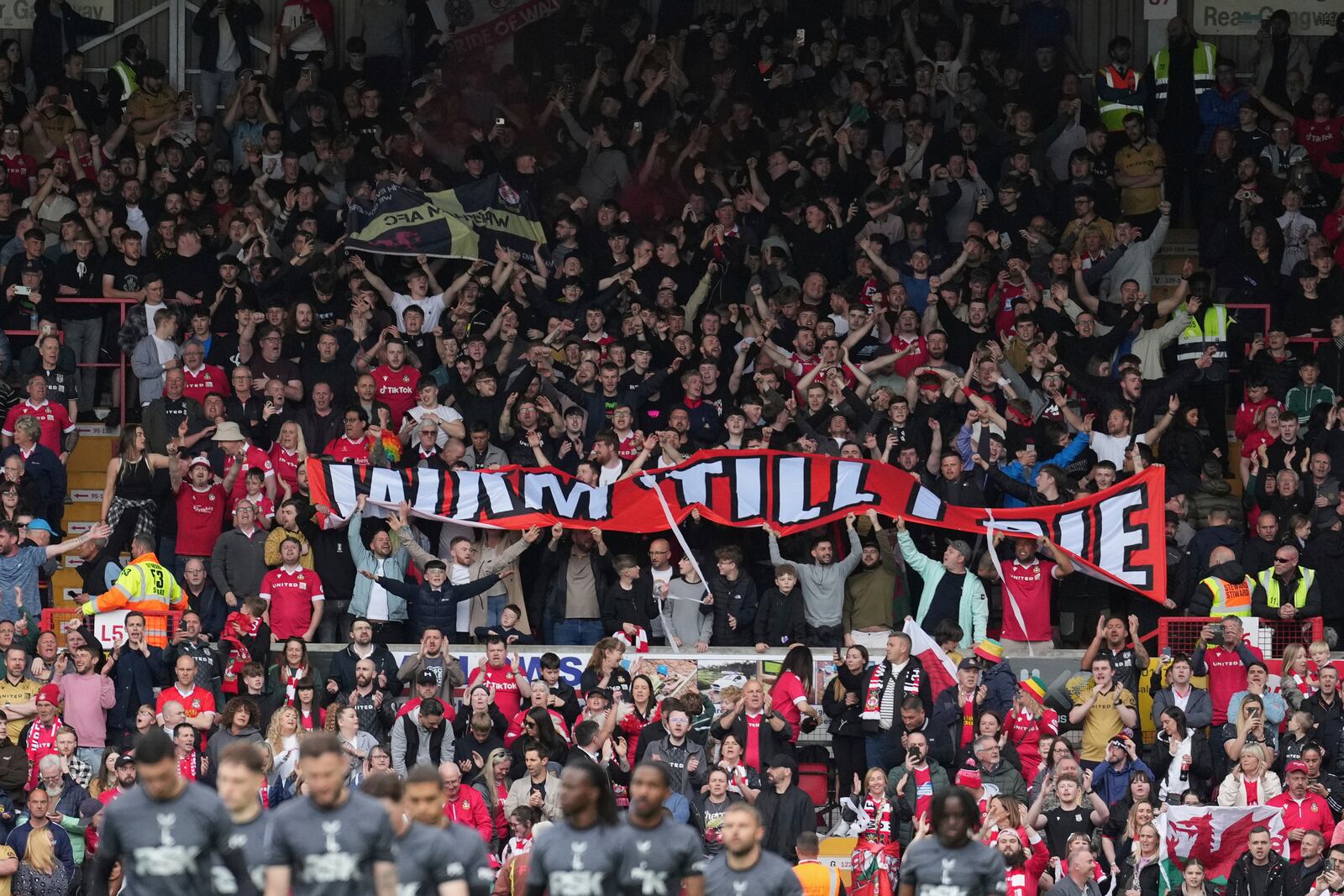 Wrexham fans support their team prior to the English League One soccer match between Wrexham and Charlton Athletic at the Racecourse ground in Wrexham, Wales, Saturday, April 26, 2025. (AP Photo/Jon Super)