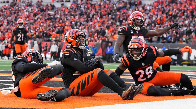 Cincinnati Bengals safety Geno Stone (22) celebrates with teammates after an interception during the second half of an NFL football game against the Cleveland Browns, Sunday, Dec. 22, 2024, in Cincinnati. (AP Photo/Jeff Dean)