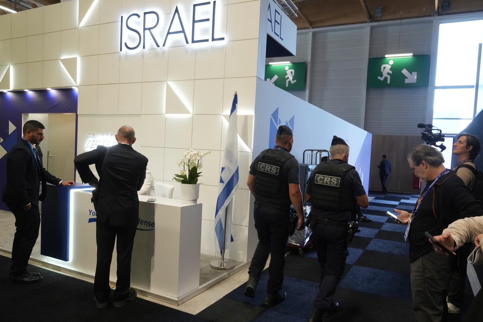 Riot police officers patrol by the Israeli pavilions at the Paris Air Show , Monday, June 16, 2025 in Le Bourget, north of Paris. (AP Photo/Michel Euler)