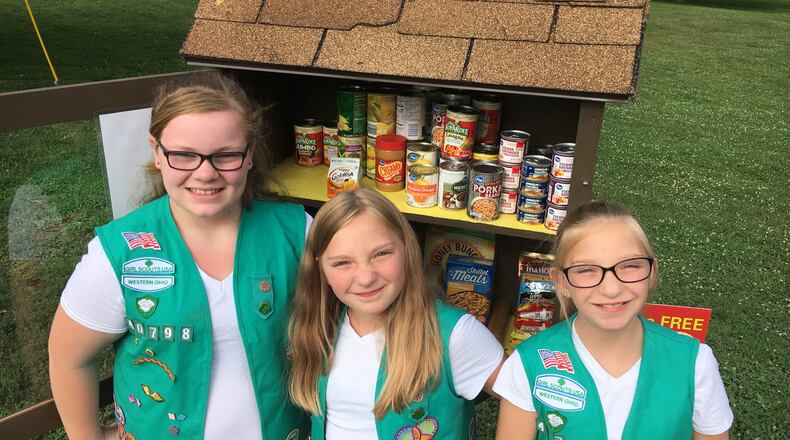 Members of Girl Scout Troop 40798 in Middletown recently built a Blessing Box that opened at Smith Park. They built the box with proceeds from Girl Scout cookie sales. From left, Amanda Reece, Gracie Lukas and Lacie Lukas. RICK McCRABB/STAFF
