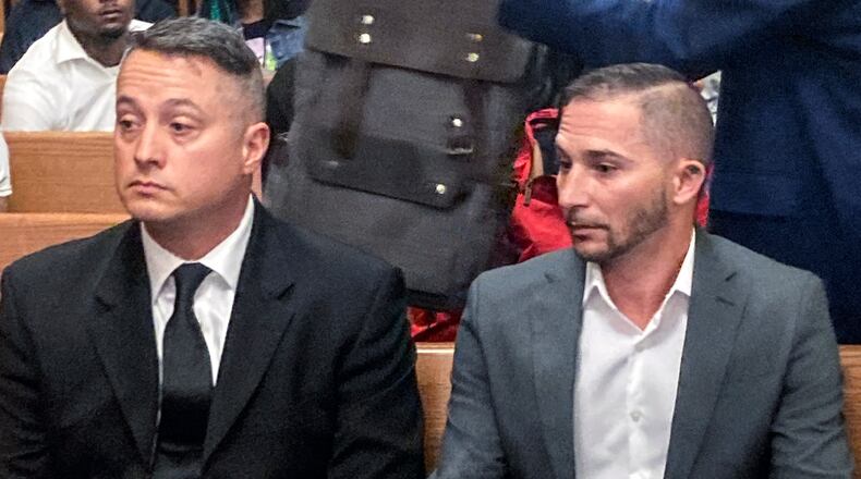 Jacob Runyan, left, and Chase Cominsky, sit in court as they are arraigned, Wednesday, Oct. 26, 2022, in Cleveland. The two pleaded not guilty to cheating and other charges in a lucrative fishing tournament on Lake Erie in the end of September where they were accused of stuffing five walleye with lead weights and fish filets. (AP Photo/Mark Gillispie)