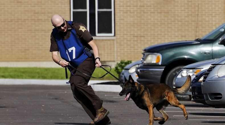 Police officers and their canine partners from several states participate in the United States Police Canine Association region 5 trials Monday, May 16, 2022 at Berachah Church in Middletown. NICK GRAHAM/STAFF