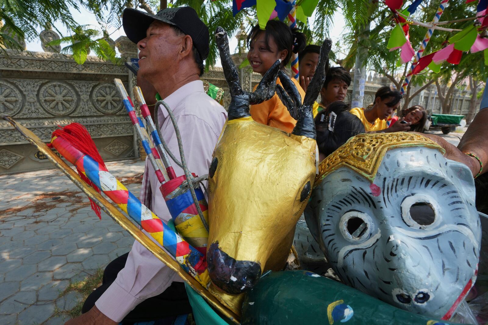 Local blessing dancers prepare a traditional mask tools as they head to dance through the villages to celebrate the traditional New Year holiday at the outskirts of Phnom Penh, Cambodia, Sunday, April 13. 2025. People celebrate the traditional New Year holiday between April 14-16. (AP Photo/Heng Sinith)