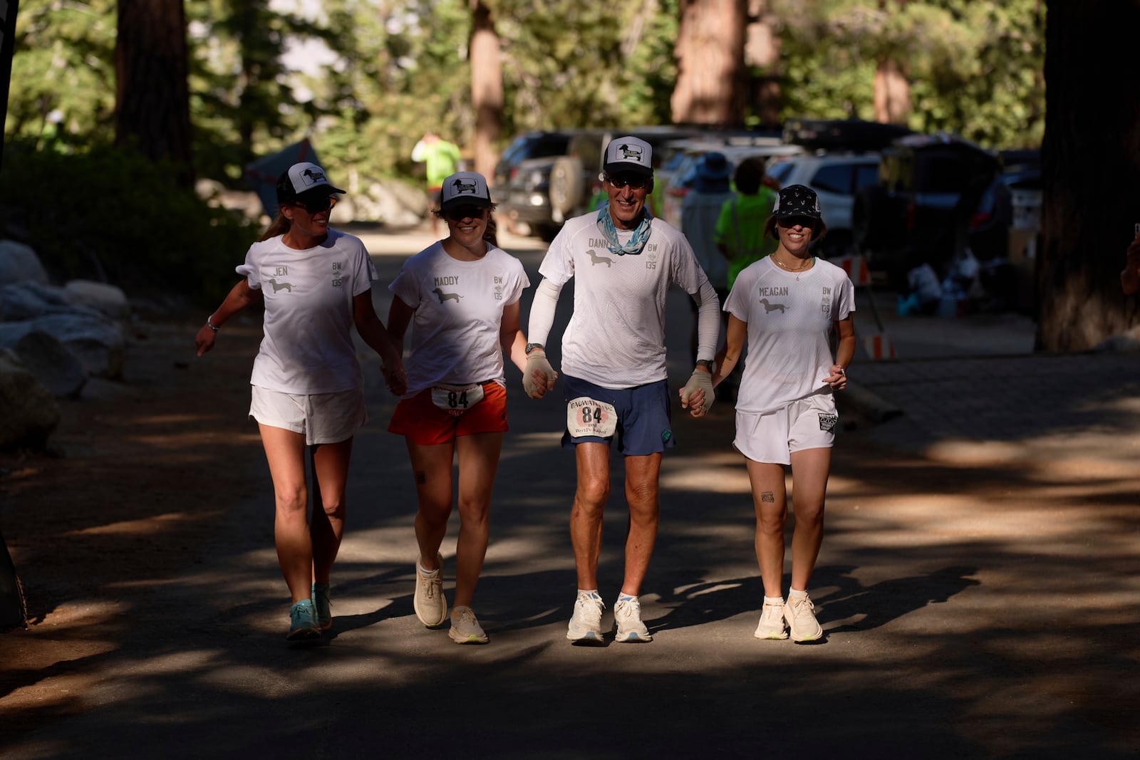 Danny Westergaard, second from right, nears the finish line of the Badwater 135 Ultramarathon beside daughters Meagan Westergaard, right, Madison Westergaard, and cousin Jennifer Drain, left, Wednesday, July 9, 2025, at Whitney Portal near Lone Pine, Calif. (AP Photo/John Locher)