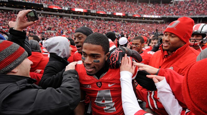 C.J. Barnett #4 of the Ohio State Buckeyes is congratulated by fans after Ohio State defeated the Michigan Wolverines 26-21 at Ohio Stadium on November 24, 2012 in Columbus.