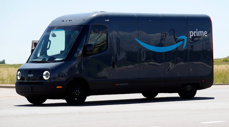 FILE- A Rivian electric van delivers packages for Amazon Prime. FILE