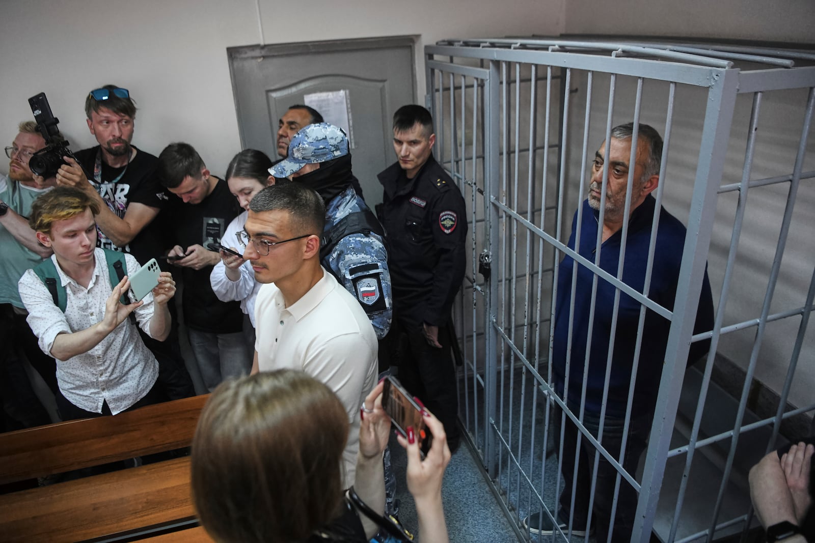 Bakir Safarov, a native of Azerbaijan, right, who faces charges as part of a Russian investigation of several killings, attends a court hearing in Yekaterinburg, Russia, on Tuesday, July 1, 2025. (AP Photo)