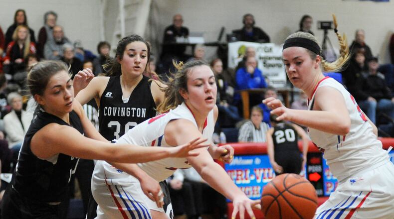 Sisters Meghan (center) and Maddie Downing (right) are the Tri-Village “Twin Towers.” Tri-Village wrapped up a Cross County Conference title on Thursday. MARC PENDLETON / STAFF
