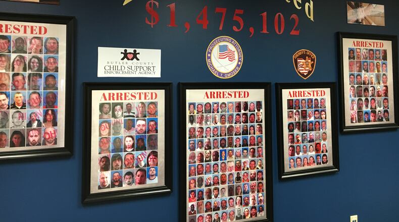Butler County Prosecutor Michael Gmoser has erected what he calls the “Wall of Shame” in his office. The display includes photos of deadbeat parents his office has successfully prosecuted. DENISE G. CALLAHAN/STAFF