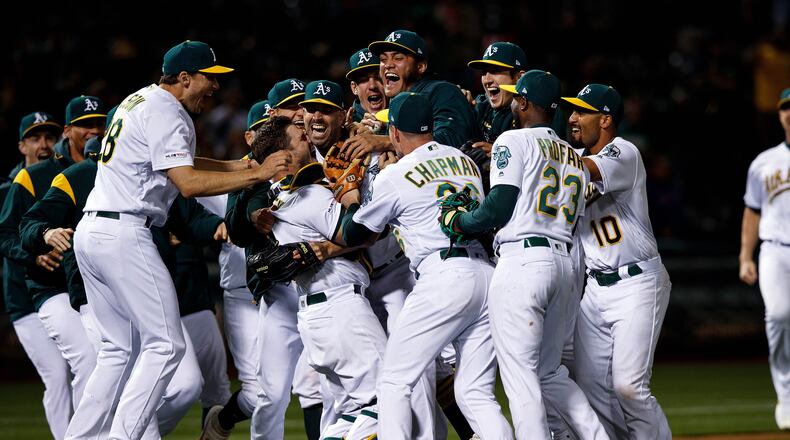 OAKLAND, CA - MAY 07: Mike Fiers #50 of the Oakland Athletics celebrates with teammates after pitching a no hitter against the Cincinnati Reds at the Oakland Coliseum on May 7, 2019 in Oakland, California. The Oakland Athletics defeated the Cincinnati Reds 2-0. (Photo by Jason O. Watson/Getty Images)